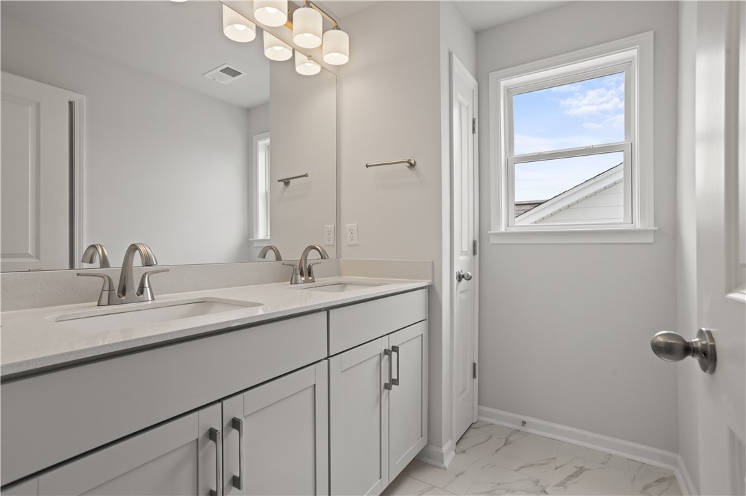555 Hydrangea Street, Unit LOT 47 Seneca, SC 29678 - Photo 32 of 38 Dual vanity with bright lighting offers practical elegance in this well-appointed bathroom.