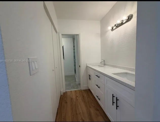 a bathroom with a granite countertop sink a shower and a mirror