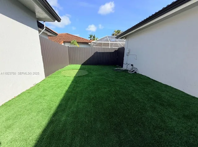 a backyard of a house with lots of green space