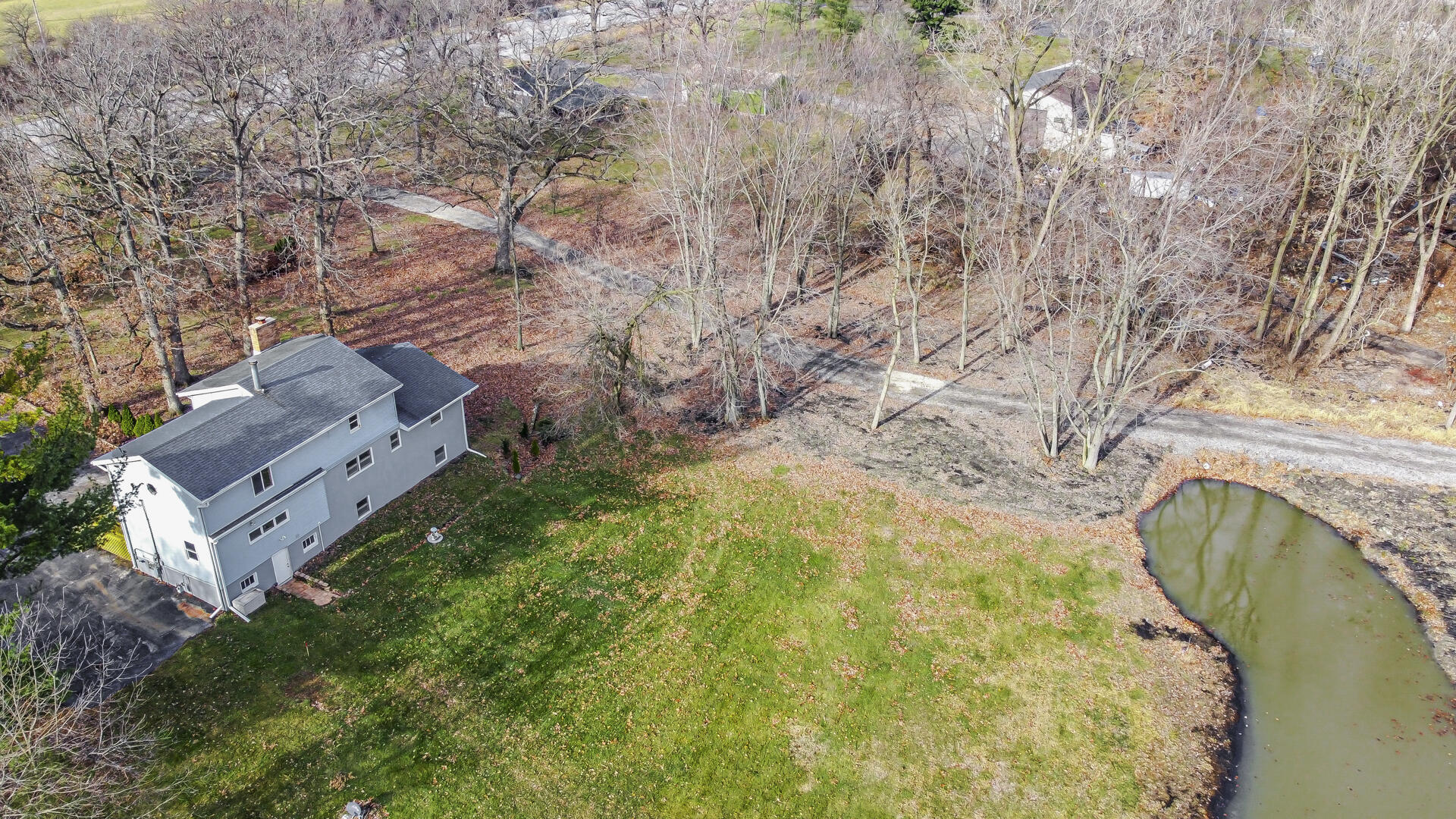 12219 Wicker Avenue Cedar Lake, IN 46303 - Photo 2 of 5 a aerial view of a house with a yard and large trees