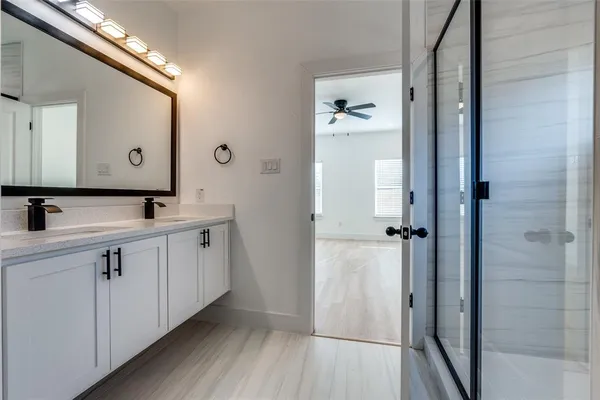a spacious bathroom with a double vanity sink and mirror