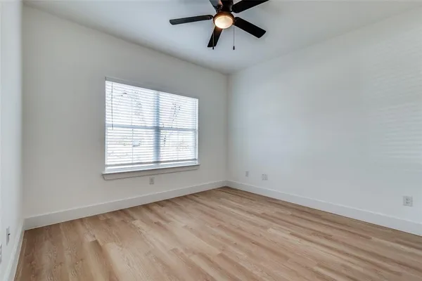 a view of a room with wooden floor and windows