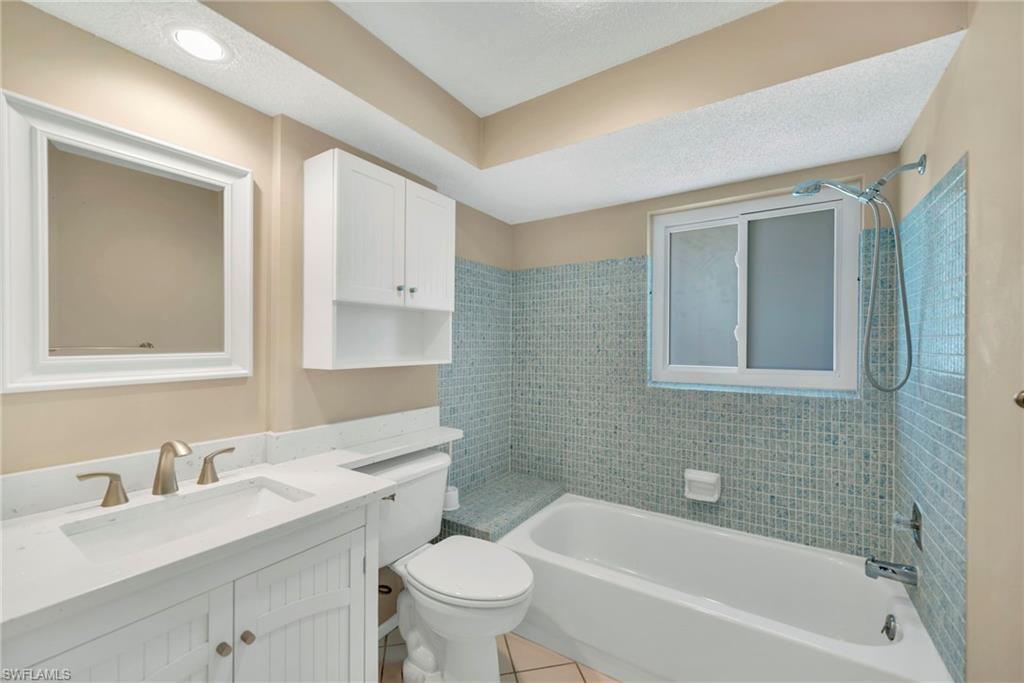 224 Potomac Place Naples, FL 34112 - Photo 16 of 17 a bathroom with a sink mirror toilet and bathtub