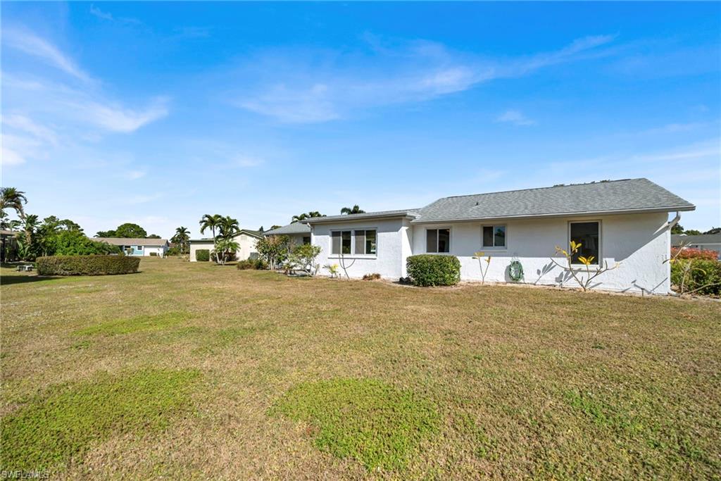 224 Potomac Place Naples, FL 34112 - Photo 3 of 17 a front view of house with yard and ocean