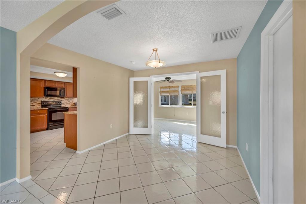 224 Potomac Place Naples, FL 34112 - Photo 10 of 17 a view of a kitchen with a sink and a refrigerator a fireplace