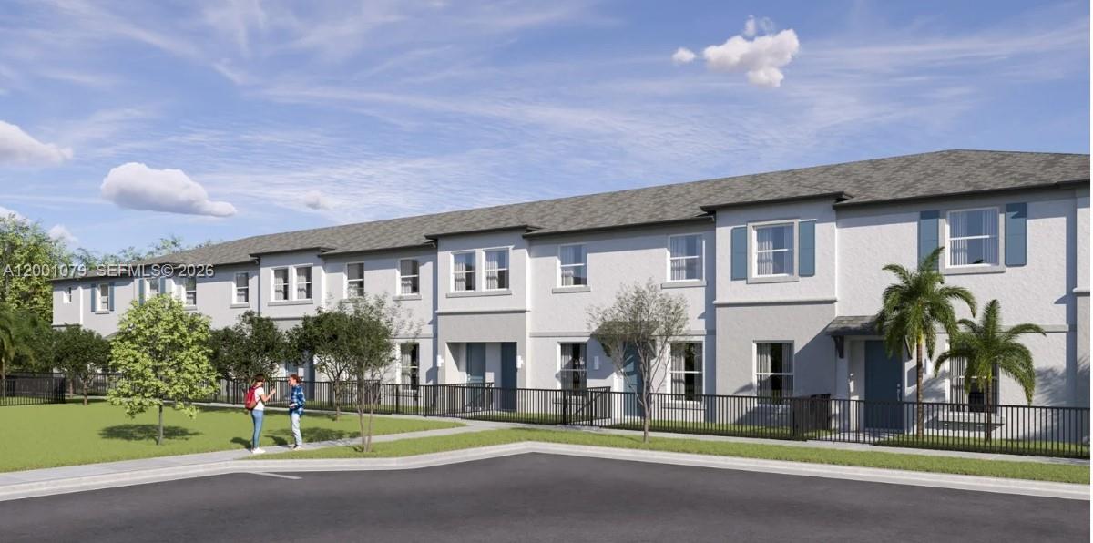 12476 Southwest 248th Street, Unit 5 Homestead, FL 33032 - Photo 1 of 10 a front view of building with yard and green space