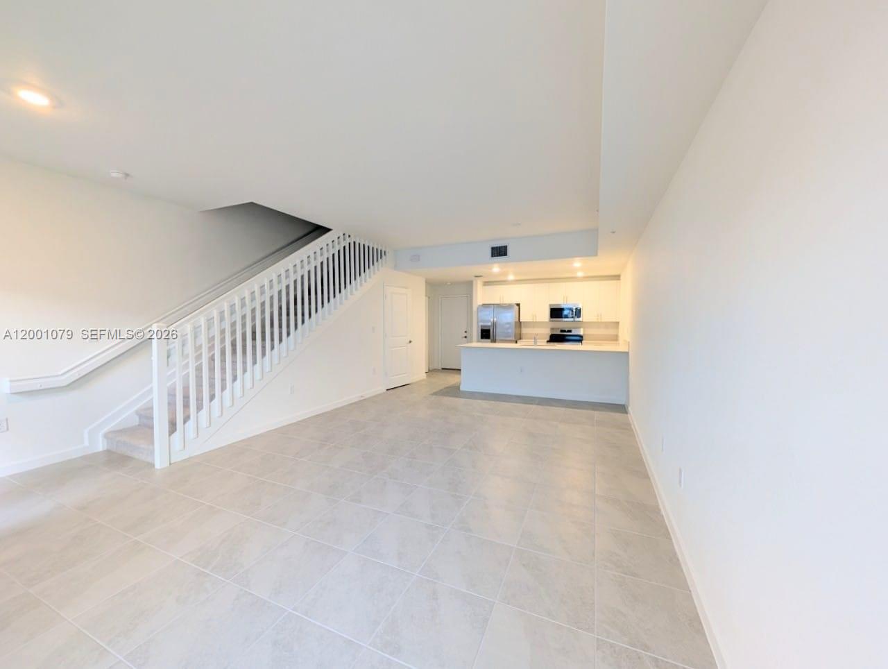 12476 Southwest 248th Street, Unit 5 Homestead, FL 33032 - Photo 4 of 10 a view of a hallway with a room and stairs