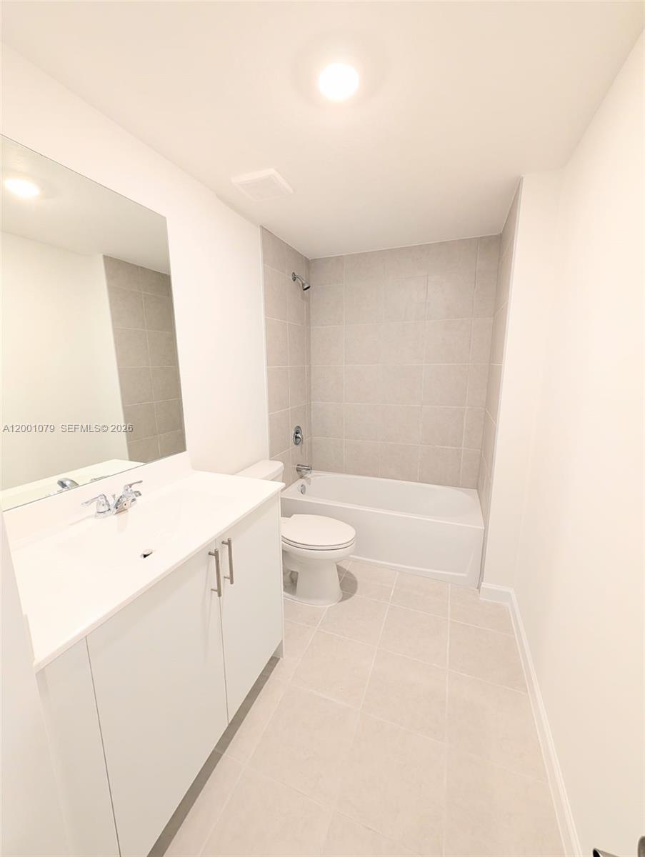 12476 Southwest 248th Street, Unit 5 Homestead, FL 33032 - Photo 9 of 10 a spacious bathroom with a granite countertop sink a toilet and a bathtub