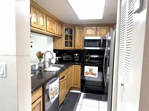 a kitchen with stainless steel appliances a stove and a microwave