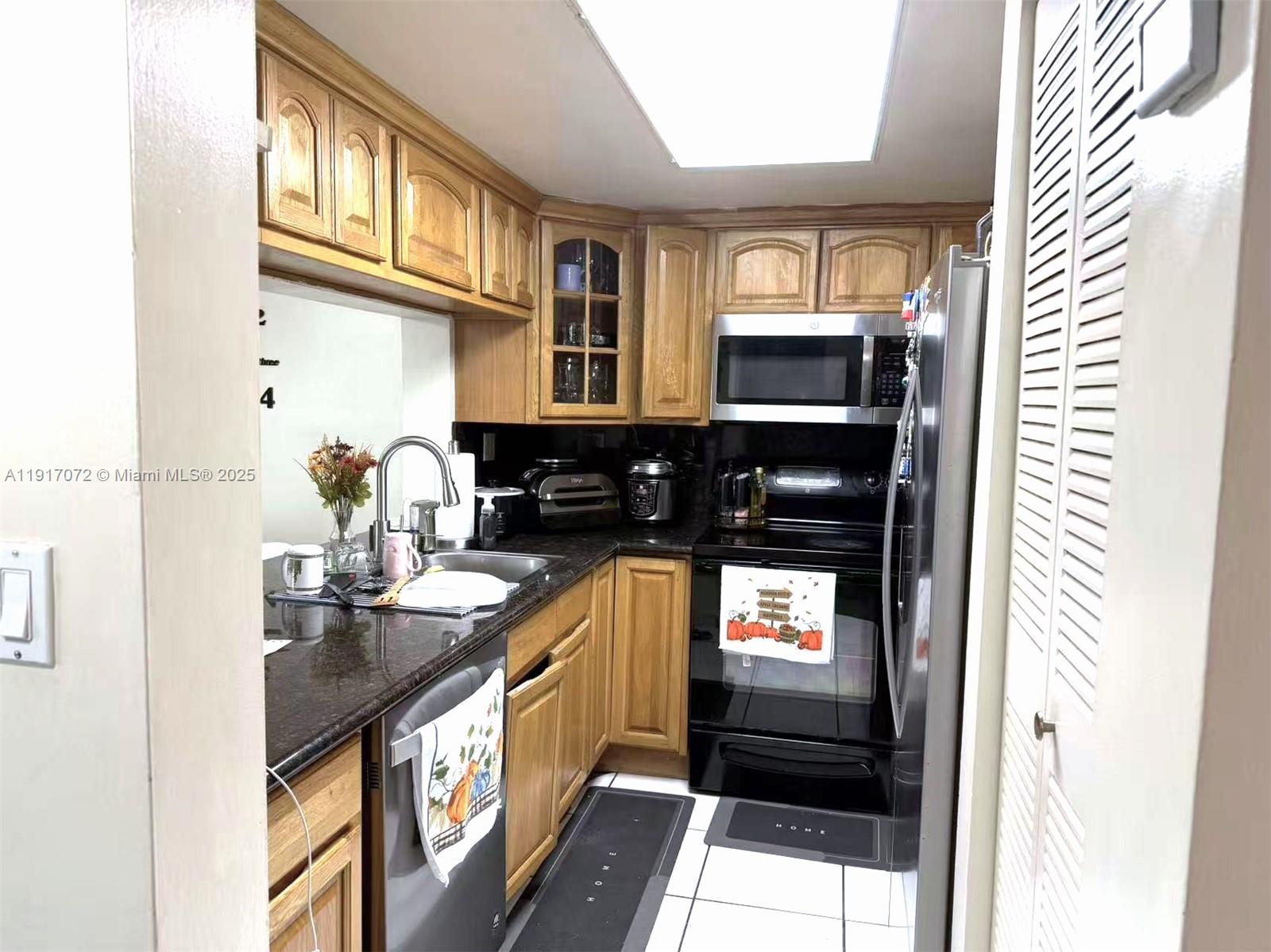 2075 Southwest 122nd Avenue, Unit 429 Miami, FL 33175 - Photo 2 of 10 a kitchen with stainless steel appliances a stove and a microwave