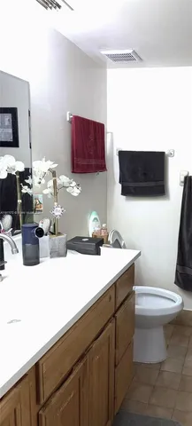 a bathroom with a sink a toilet and a mirror