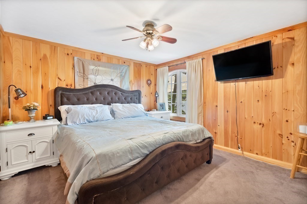 40 Over The Top Road Holland, MA 01521 - Photo 16 of 41 a bedroom with a bed a window and a flat screen tv