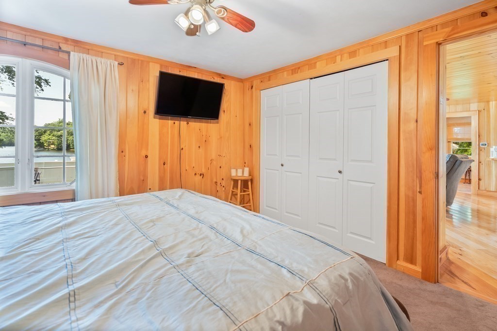 40 Over The Top Road Holland, MA 01521 - Photo 17 of 41 a view of a livingroom with wooden floor and a flat screen tv