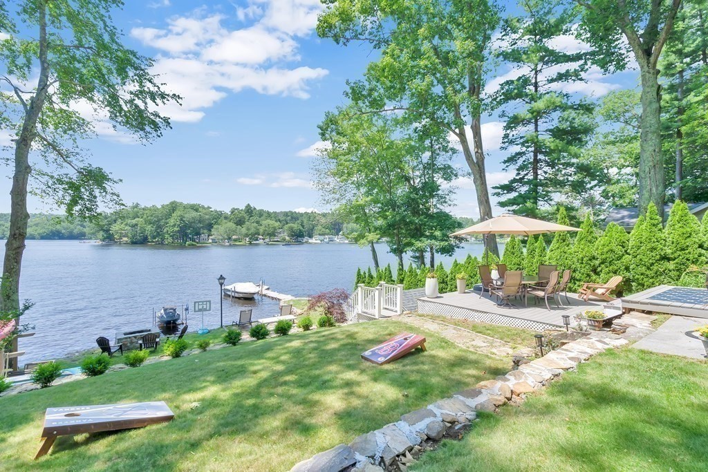 40 Over The Top Road Holland, MA 01521 - Photo 3 of 41 a view of a lake with a table and chairs under an umbrella