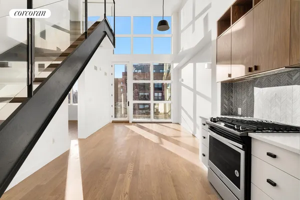 a kitchen with granite countertop a stove and a wooden floor
