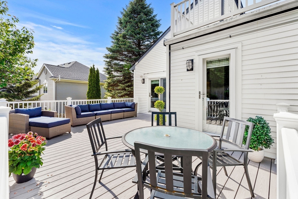 53 Gerald Road Marblehead, MA 01945 - Photo 33 of 42 a view of a patio with a dining table and chairs with potted plants