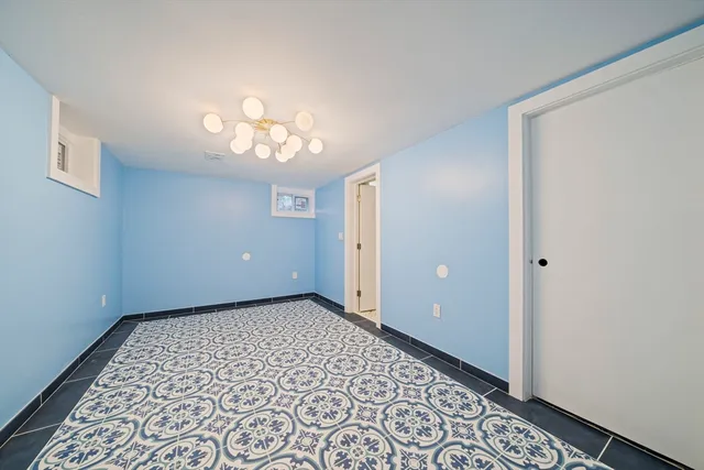a view of a hallway with a chandelier fan