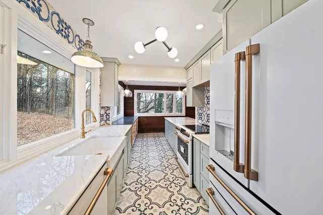 a large kitchen with a large window and stainless steel appliances