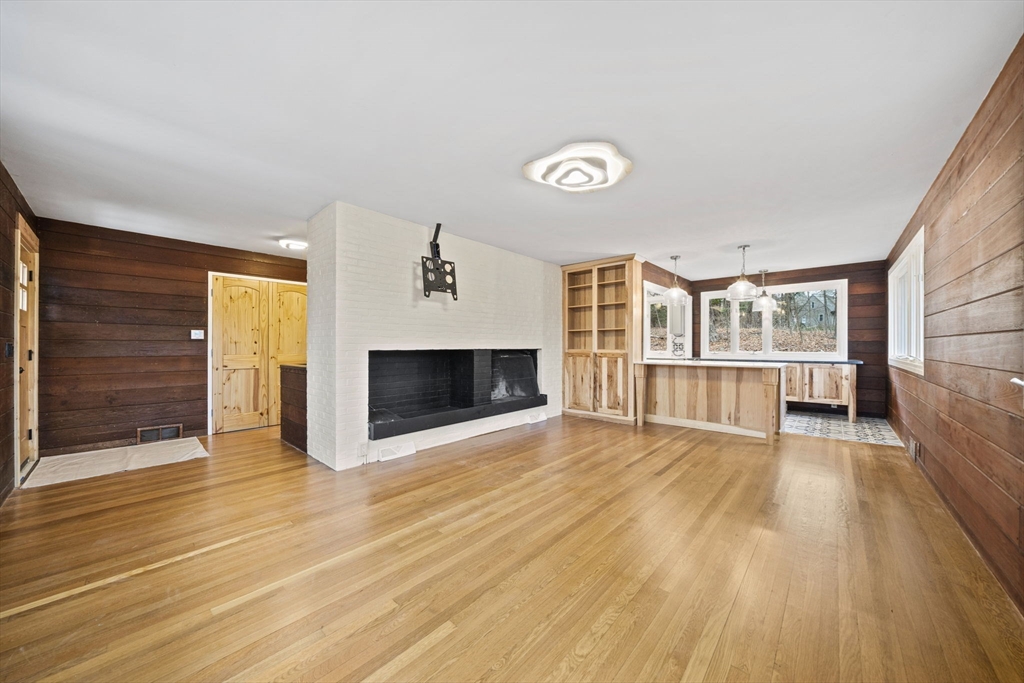 12 Sabrina Farm Wellesley, MA 02482 - Photo 5 of 16 an empty room with wooden floor and fireplace
