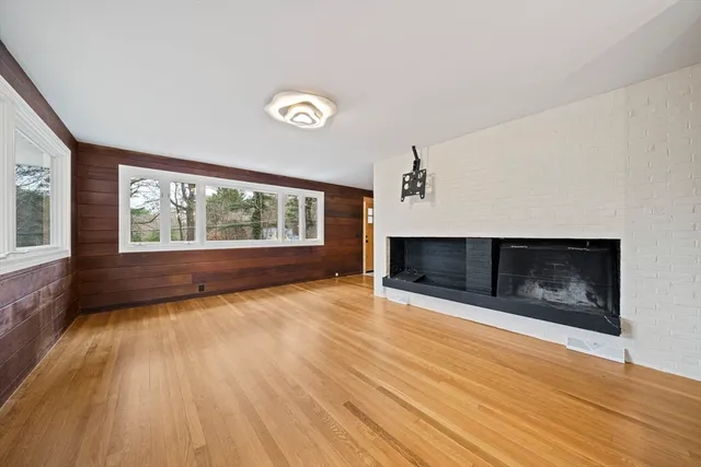 wooden floor in an empty room with a fireplace