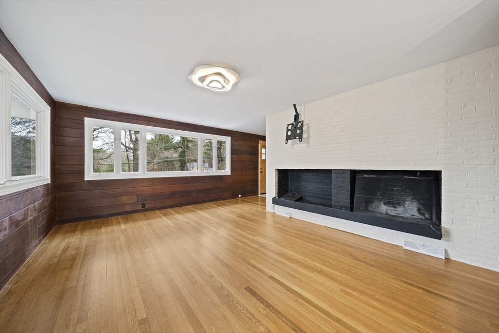 12 Sabrina Farm Wellesley, MA 02482 - Photo 7 of 16 wooden floor in an empty room with a fireplace