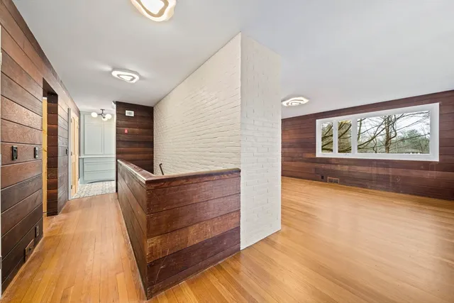 a view of room with window and wooden floor