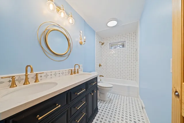 a bathroom with a sink a toilet and a mirror