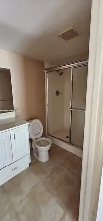 a white toilet sitting next to a bathroom sink