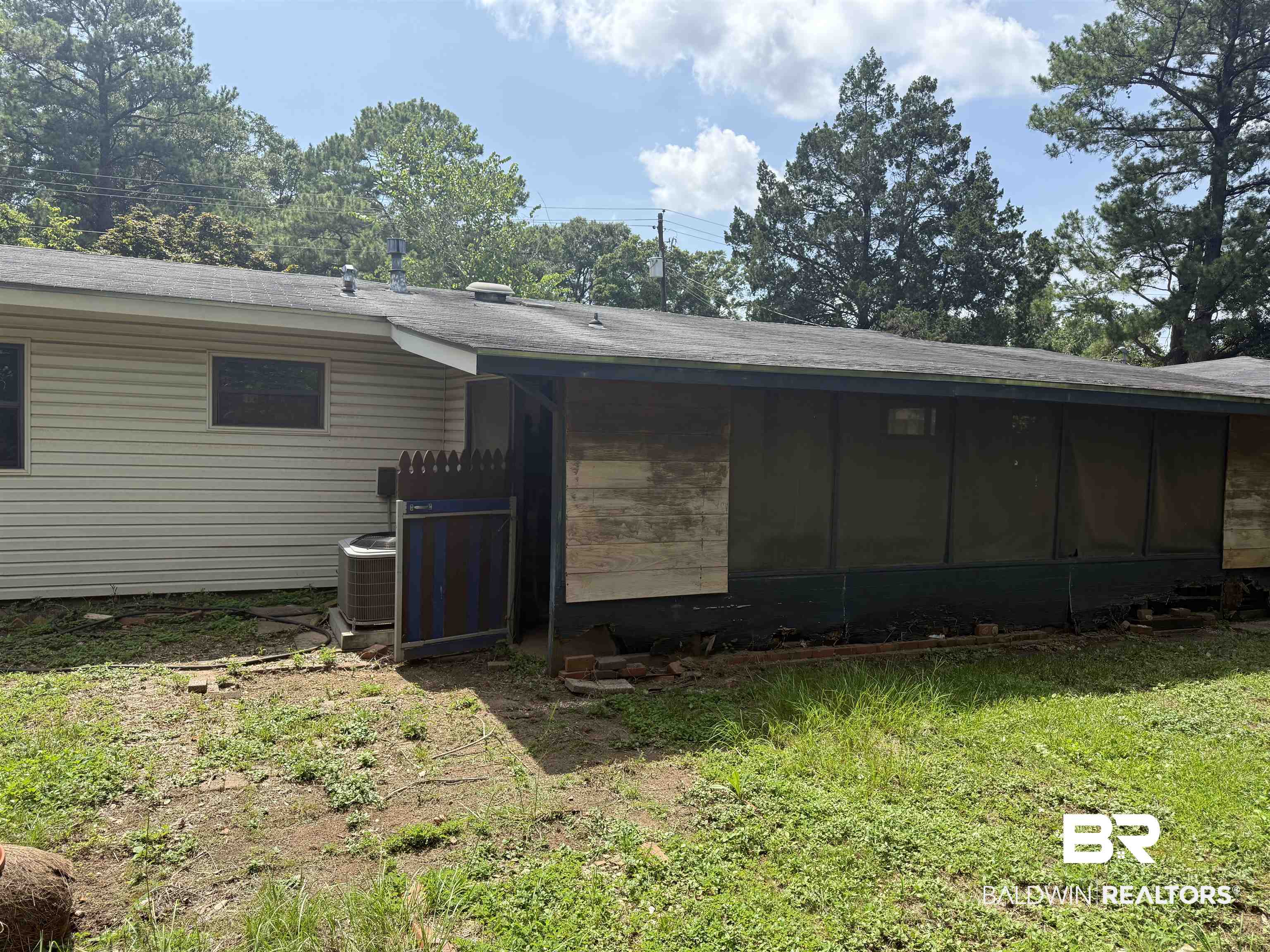 711 Wilshire Road Mobile, AL 36609 - Photo 11 of 11 Rear exterior featuring horizontal vinyl siding and an attached screened porch