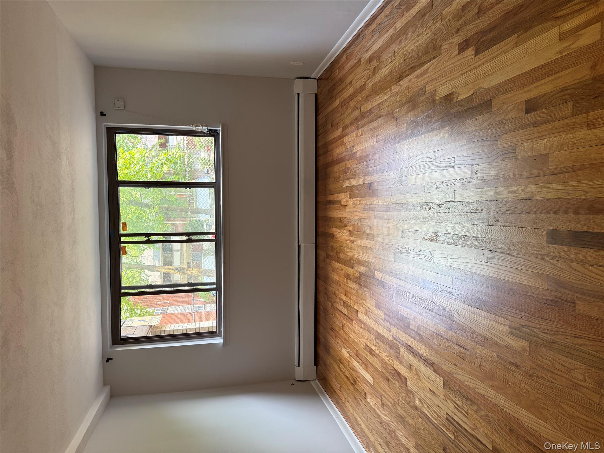 258 North Main Street, Unit C3 Spring Valley, NY 10977 - Photo 3 of 10 a view of an empty room with wooden floor and a window