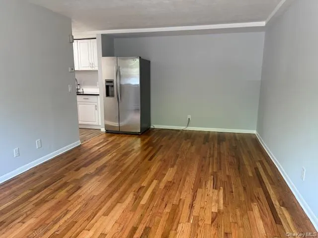 a view of a kitchen with wooden floor and a sink