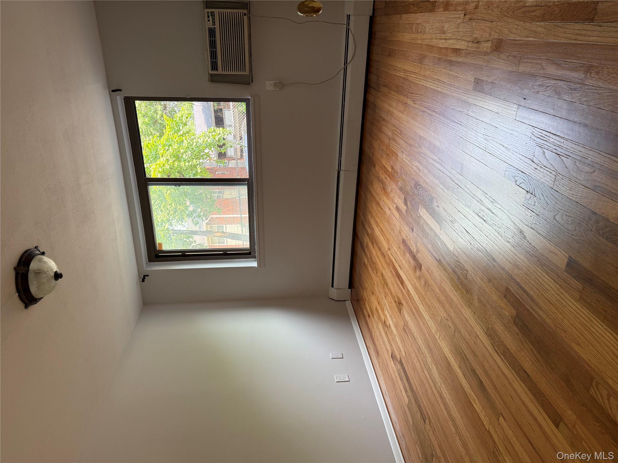258 North Main Street, Unit C3 Spring Valley, NY 10977 - Photo 5 of 10 an empty room with wooden floor and windows