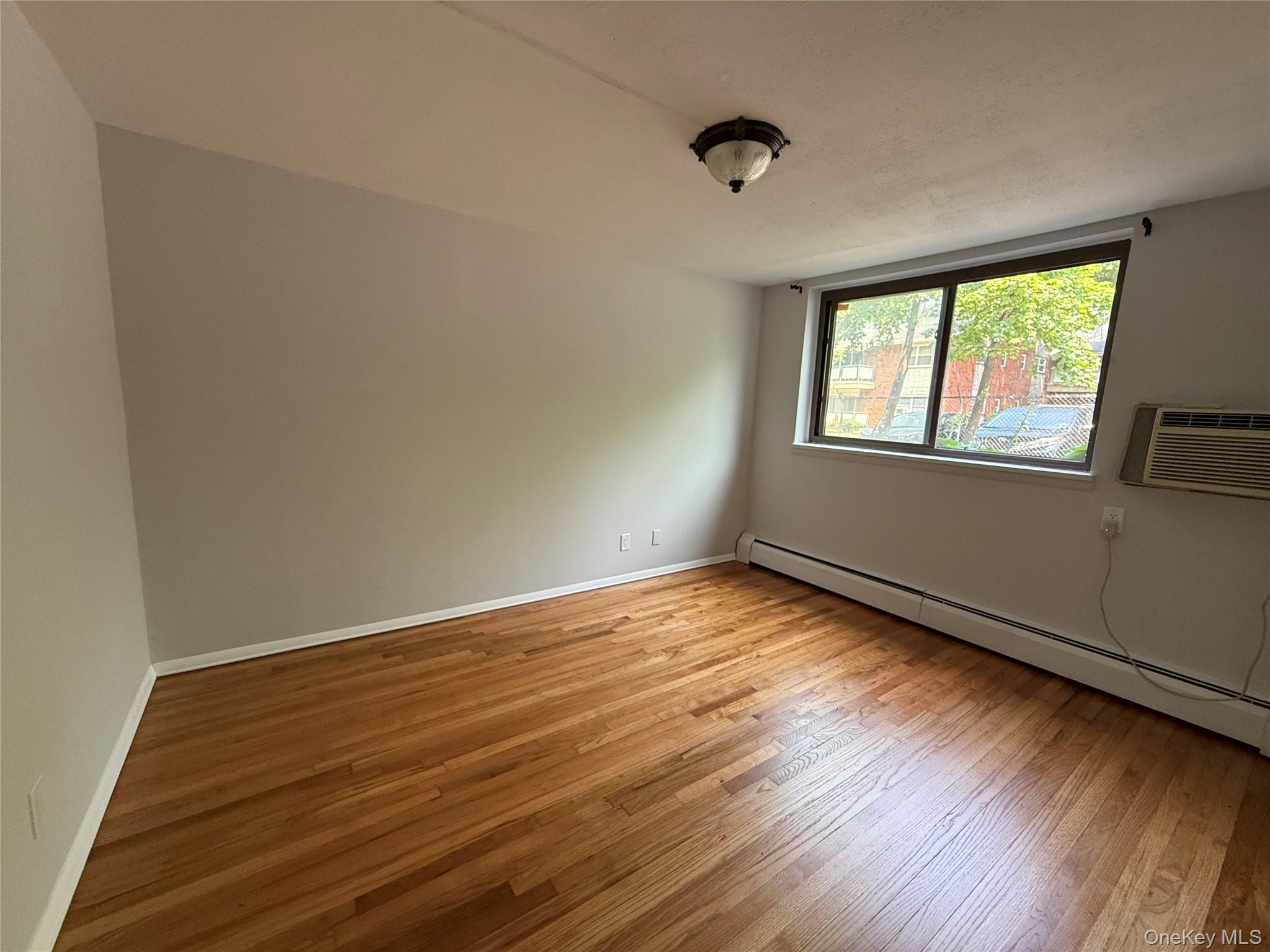 258 North Main Street, Unit C3 Spring Valley, NY 10977 - Photo 6 of 10 an empty room with wooden floor and windows