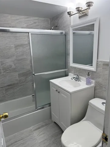 a bathroom with a sink mirror vanity and toilet