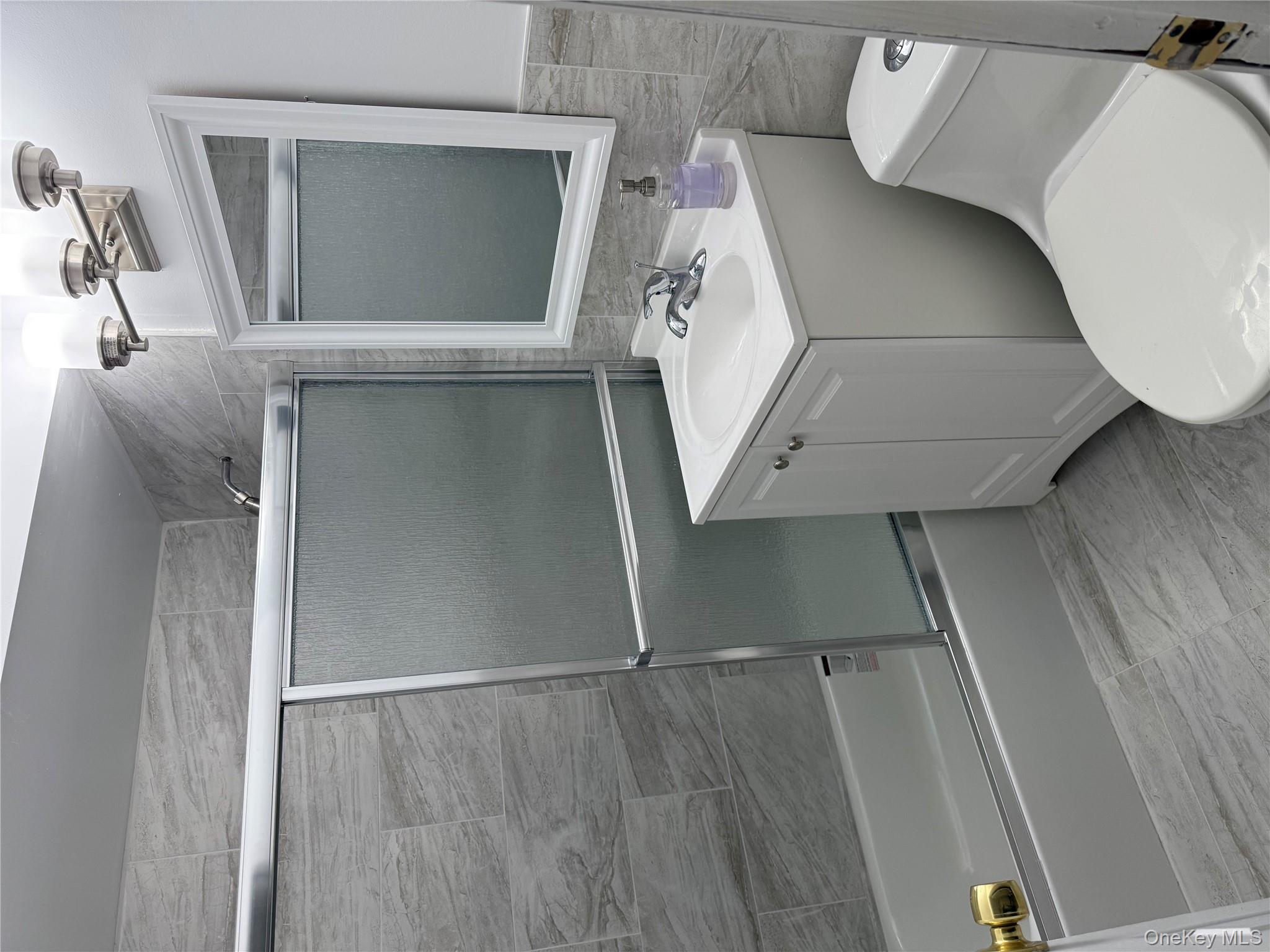 258 North Main Street, Unit C3 Spring Valley, NY 10977 - Photo 9 of 10 a bathroom with a sink mirror vanity and toilet