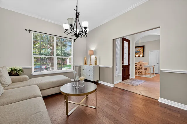 a living room with furniture and a chandelier