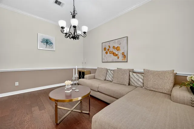 a living room with furniture and a chandelier