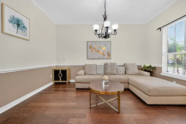a living room with furniture and a chandelier