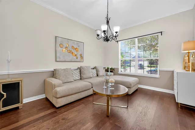 a living room with furniture and a chandelier