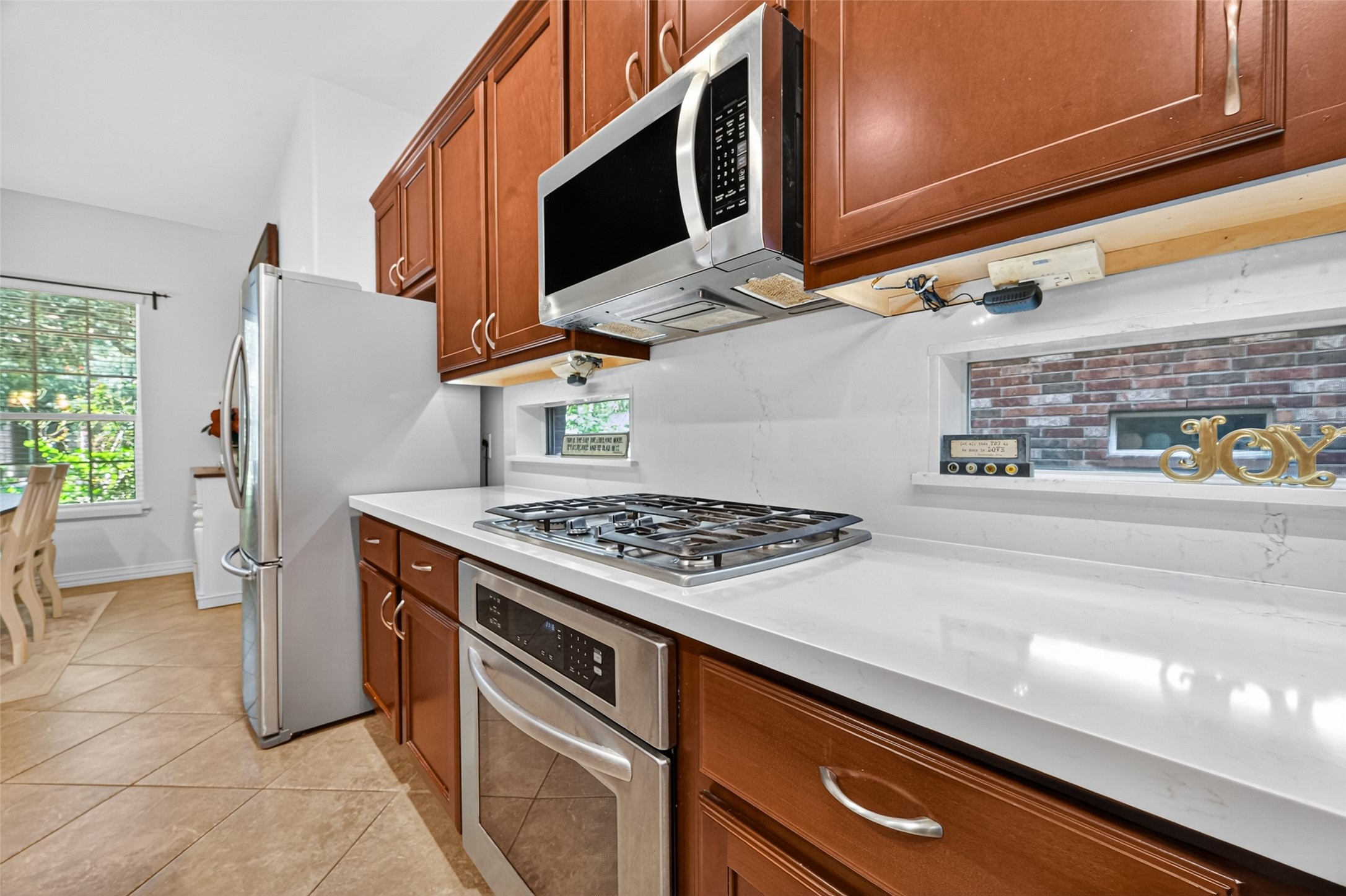 24914 Hazel Ranch Drive Katy, TX 77494 - Photo 18 of 45 a kitchen with a stove and a microwave