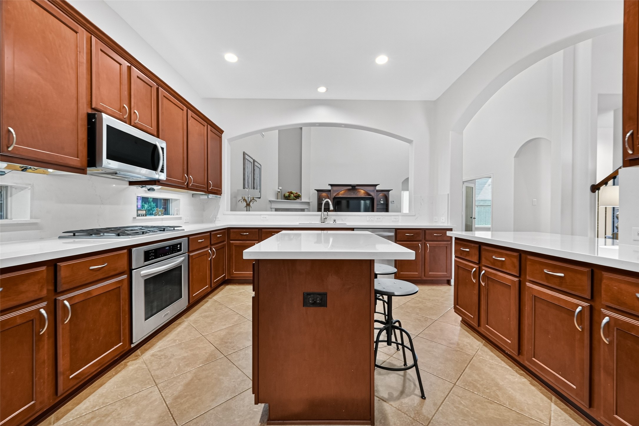 24914 Hazel Ranch Drive Katy, TX 77494 - Photo 2 of 45 a kitchen with stainless steel appliances granite countertop wooden cabinets a sink a stove a refrigerator and island with wooden floor