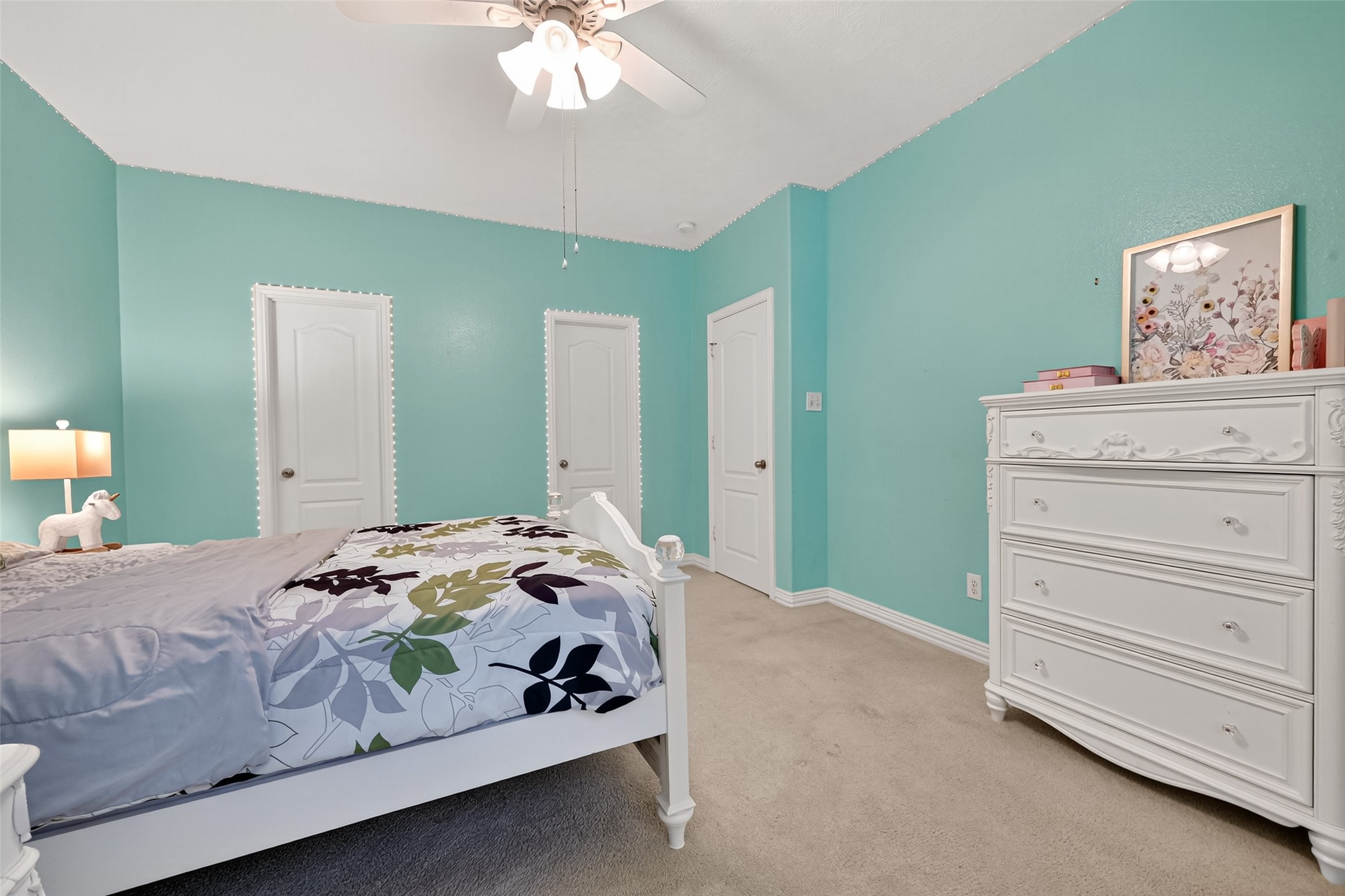 24914 Hazel Ranch Drive Katy, TX 77494 - Photo 25 of 45 a bedroom with a bed and a chandelier