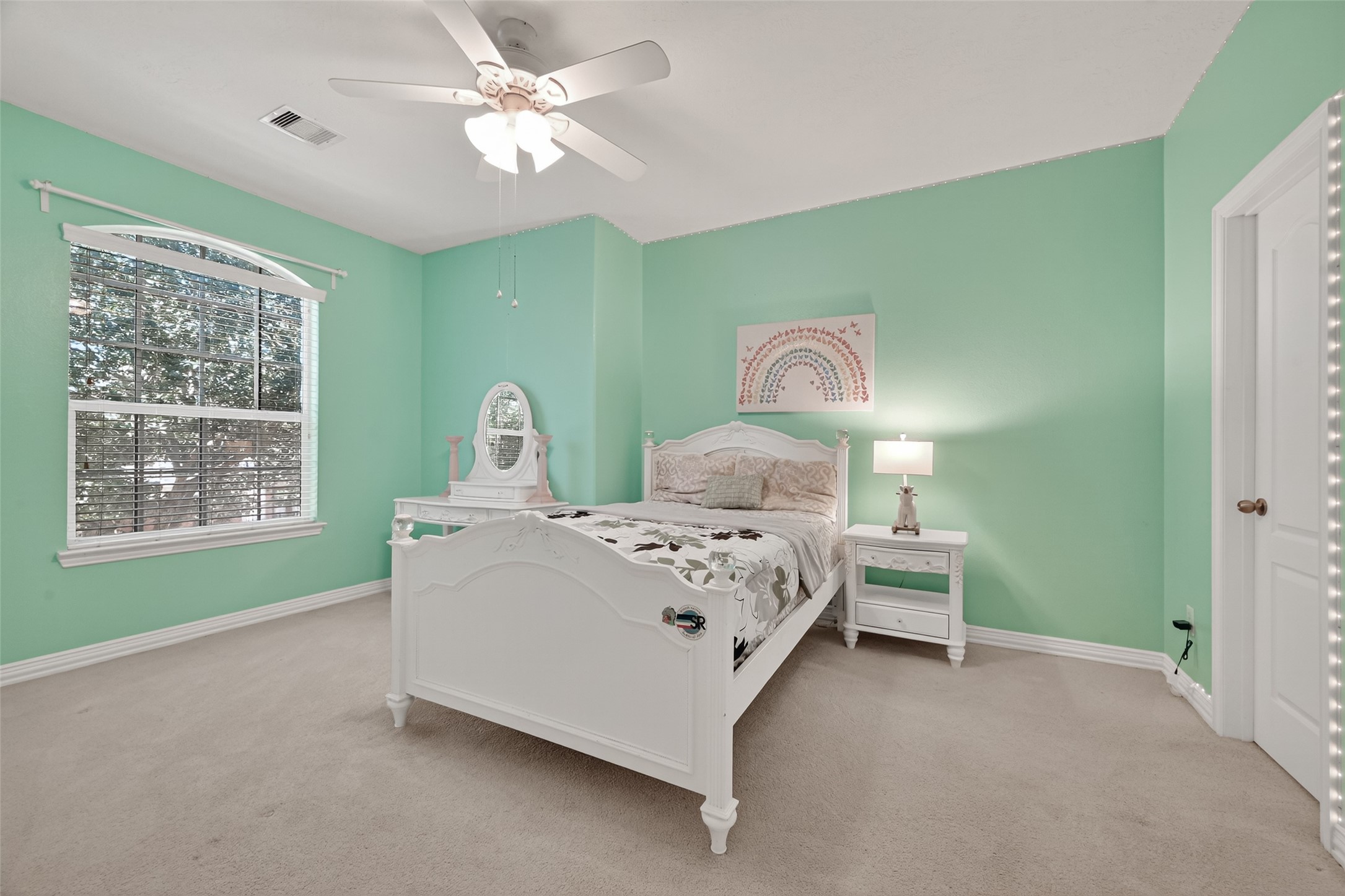 24914 Hazel Ranch Drive Katy, TX 77494 - Photo 26 of 45 a bedroom with a bed lamp and a large window