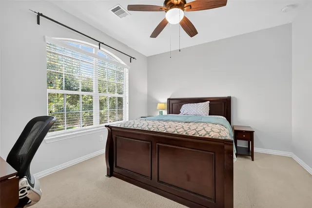 a bedroom with a bed and a chair