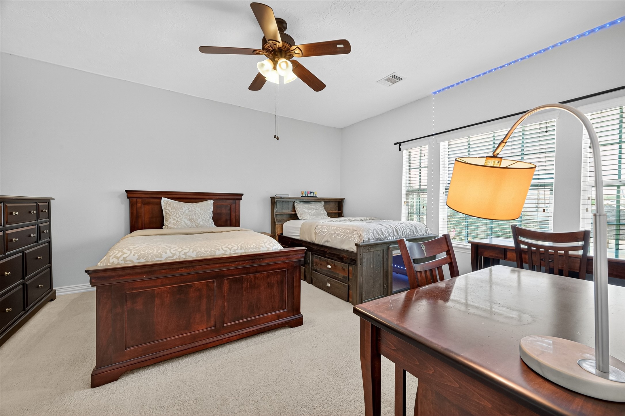 24914 Hazel Ranch Drive Katy, TX 77494 - Photo 31 of 45 a bedroom with a bed a dresser and window