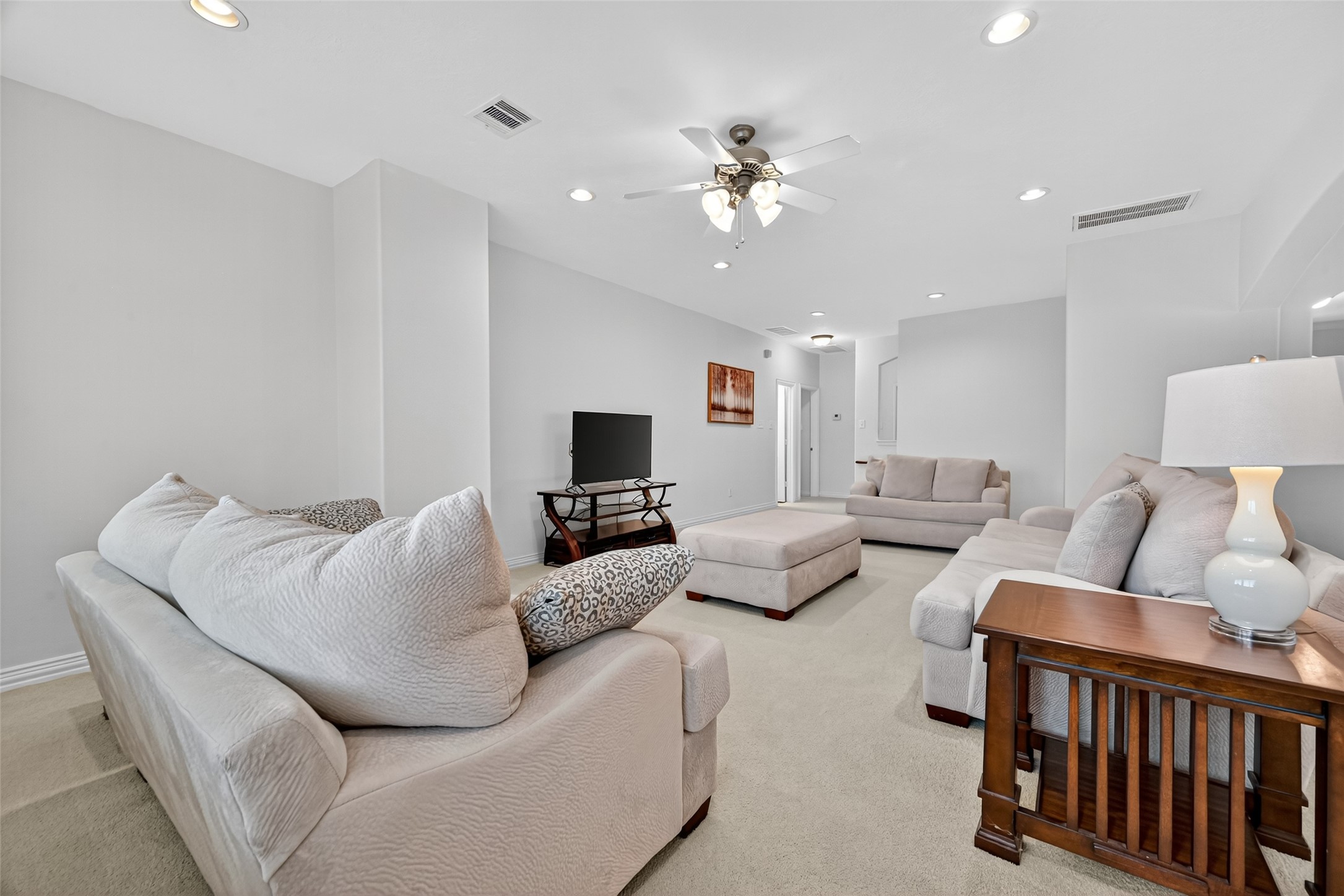 24914 Hazel Ranch Drive Katy, TX 77494 - Photo 32 of 45 a living room with furniture and a flat screen tv