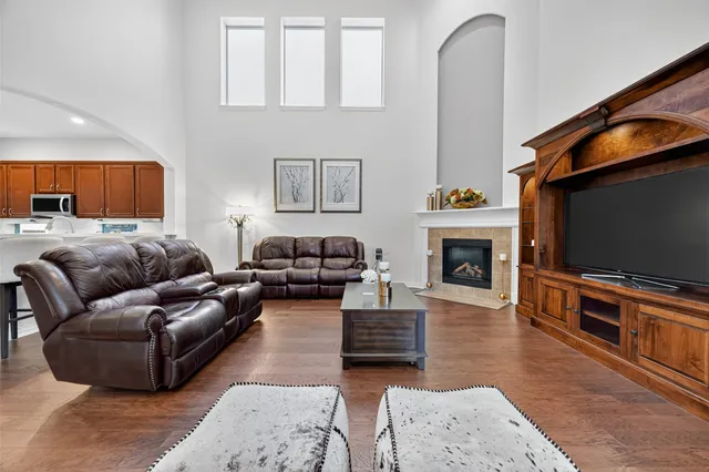 a living room with furniture a flat screen tv and a fireplace