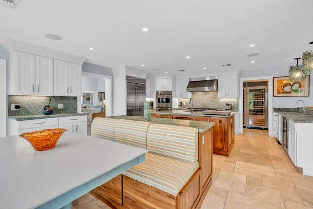 a bedroom with furniture and a large window