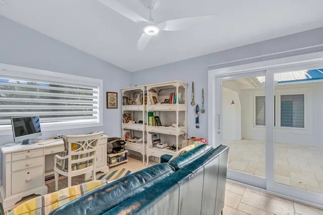 a very nice looking living room with a large window and a book shelf