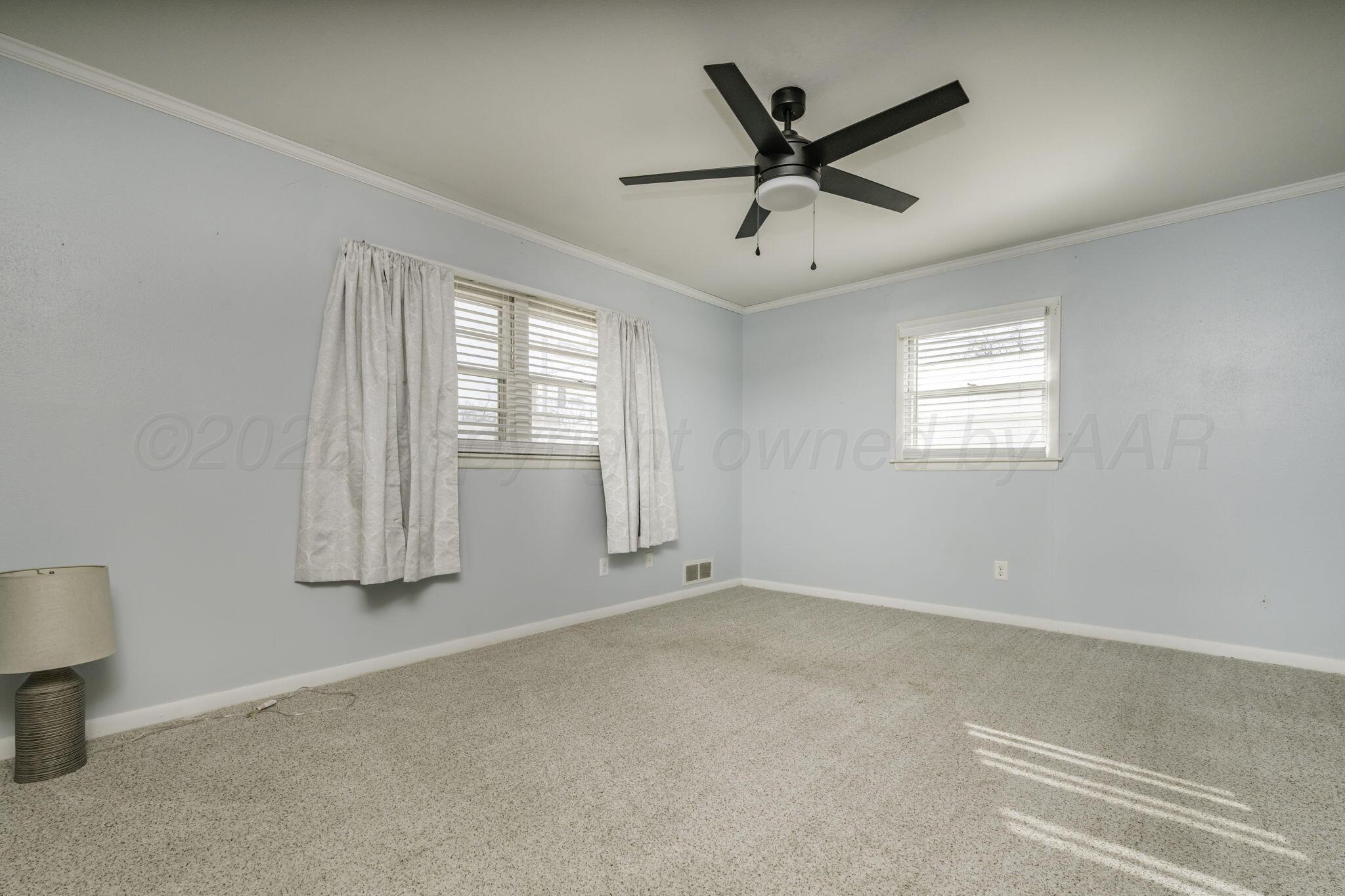 3228 South Travis Street Amarillo, TX 79109 - Photo 17 of 22 a view of room with window and ceiling fan